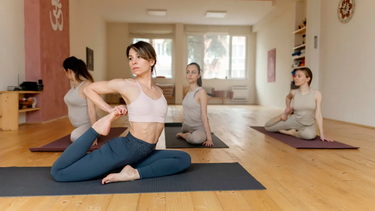 Beginner yoga class at Inlet Yoga studio in Manasquan NJ with students practicing a seated twist pose