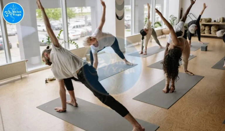 Beginners yoga class at Inlet Yoga Studio in Manasquan NJ with students practicing a side stretch on mats