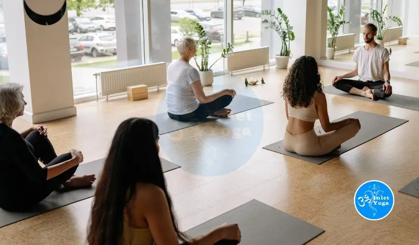 Students sitting on mats during yoga teacher training 200 hour session at Inlet Yoga Studio Manasquan NJ