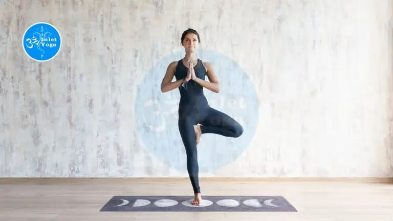 Certified Yoga Instructor practicing tree pose during yoga teacher training in a bright, modern yoga studio